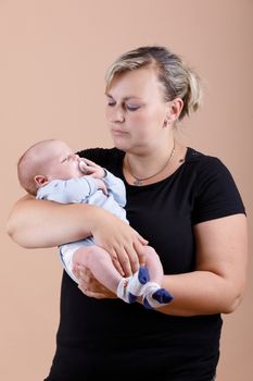 mother with her cute little baby boy, first month of the new life, studio shoot