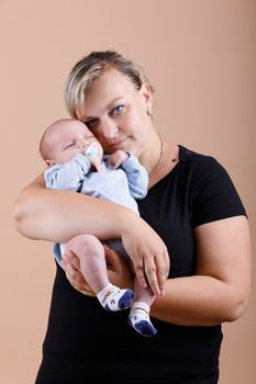 mother with her cute little baby boy, first month of the new life, studio shoot