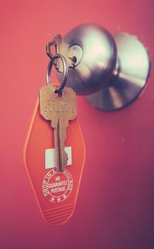 Vacation Detail Of A Retro Motel Room Key In The Door Handle