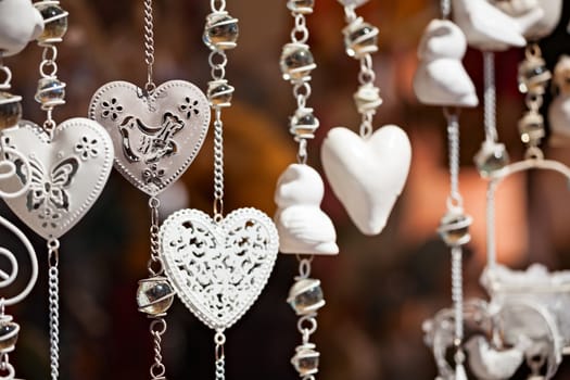 White hanging heart souvenirs in a market