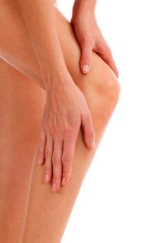 Closeup shot of woman holding sore knee, isolated on white background