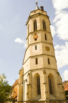 Superb tower of an old stone church in a German village