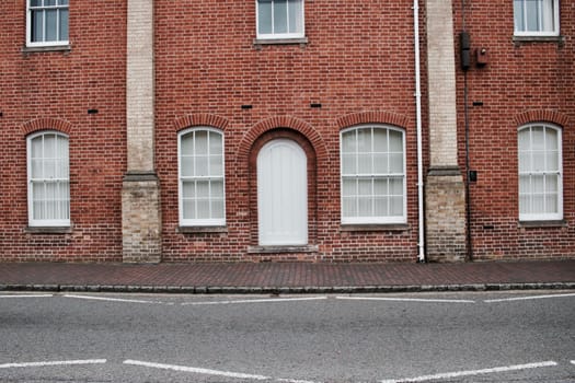 Brick old building with a white doors and windows in Newport Pagnell. Buckinghamshire.
