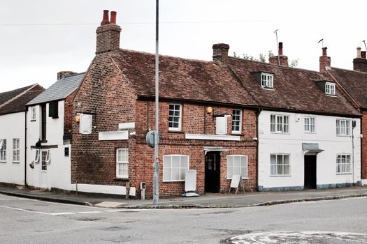 Two old buildings near the road in Newport Pagnell Town Centre. Buckinghamshire.