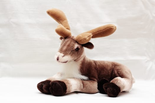 Soft toy reindeer isolated on white background.