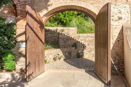 Twin open doors to the courtyard at the Alhambra palace in Granada, Spain, Europe on a bright sunny summer day