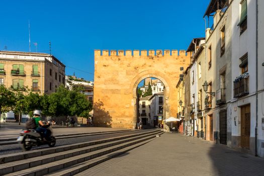 old Entrance wall to the city of Granada, Spain, Europe during golden hour of sunset on a bright sunny day