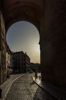 old arch wall to the city of Granada, Spain, Europe during golden hour of sunset on a bright sunny day