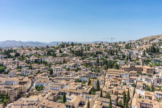 Aerial view of the city of Granada, Albaycin , viewed from the Alhambra palace in Granada, Spain, Europe on a bright summer day with blue sky