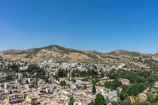 Aerial view of the city of Granada, Albaycin , viewed from the Alhambra palace in Granada, Spain, Europe on a bright summer day with blue sky