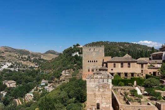 View of the Nasrid Palaces (Palacios Nazaries)  in Alhambra, Granada on a beautiful summer day, Spain, Europe, clear blue sky