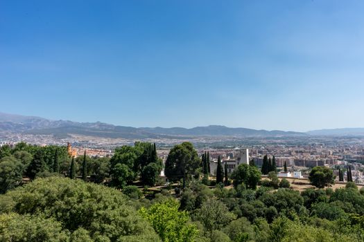 City outskirts of Granada, Albaycin , viewed from the Alhambra palace in Granada, Spain, Europe on a bright summer day with blue sky