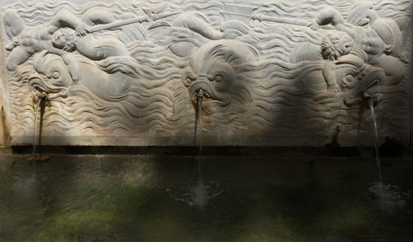 Cool Water fountain with fish in the Alhambra in Granada, Spain, Europe on a bright sunny day