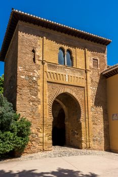 Ruins of former ancient fortress Alhambra. Granada, Andalusia, Spain, Europe on a bright sunny day with clear blue skiy