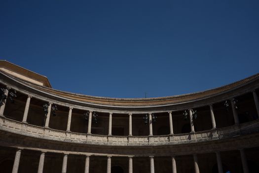 The Colosseum, columns and atrium of Alhambra palace, Granada, Spain, Europe on a bright sunny summer day with clear blue sky