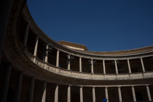 The Colosseum, columns and atrium of Alhambra palace, Granada, Spain, Europe on a bright sunny summer day with clear blue sky