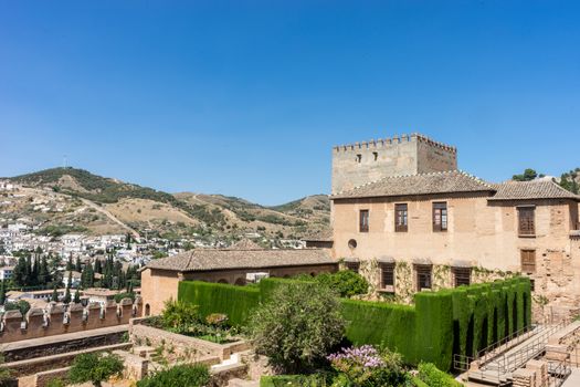 View of the Nasrid Palaces (Palacios Nazaries)  in Alhambra, Granada on a beautiful summer day, Spain, Europe, clear blue sky