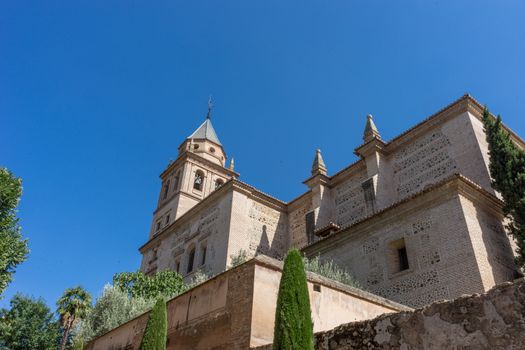 St. Mary Church of the Alhambra (Church of Santa Maria de la Alhambra) at the Alhambra Palace complex in Granada, Andalusia, Spain, Europe on a bright sunny day with blue sky