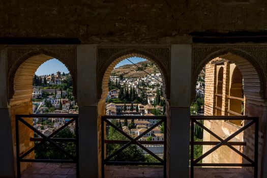 View of the Albayzin district of Granada, Spain, from a window in the Alhambra palace near sunset at Granada, Spain, Europe on a bright sunny day