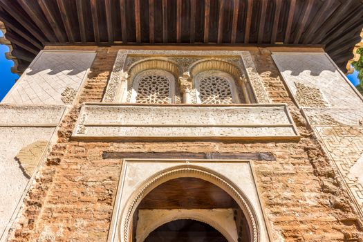 Moorish Islamic Arch above a wooden door in Granada, Spain, Europe on a bright sunny day