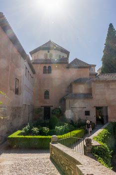 The palace of the Nasrid at Alhambra, Granada, Spain on a brighr summer day with sun flare