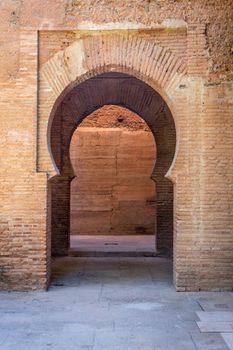 An Arch at the Alhambra Palace in Granada, Spain, Europe on a bright sunny day with blue sky