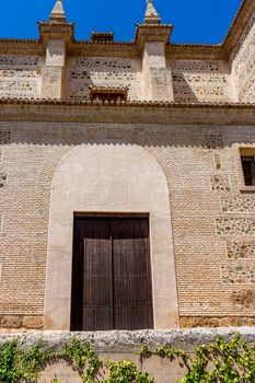 Moorish Islamic Arch above a wooden door in Granada, Spain, Europe on a bright sunny day