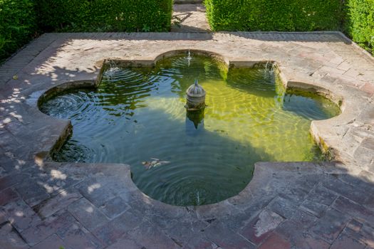 Cool Water fountain in the Alhambra in Granada, Spain, Europe on a bright sunny day