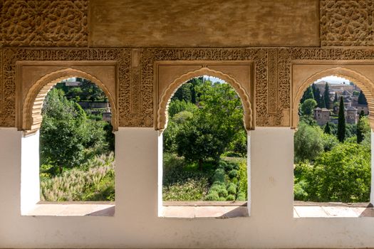 View of the Albayzin district of Granada, Spain, from a window in the Alhambra palace near sunset at Granada, Spain, Europe on a bright sunny day