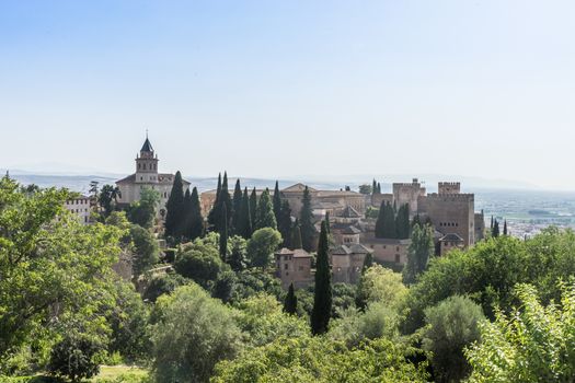 View of the bell tower of the Alhambra and tha palace from the Generalife gardens in Granada, Spain, Europe on a bright summer day