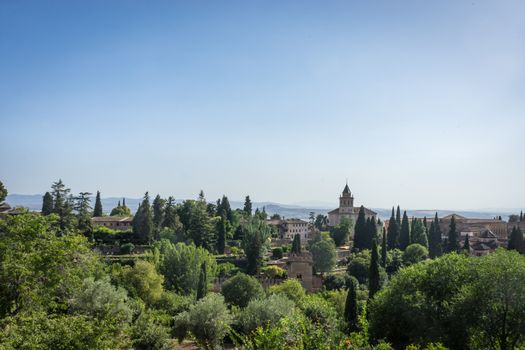 View of the bell tower of the Alhambra and tha palace from the Generalife gardens in Granada, Spain, Europe on a bright summer day