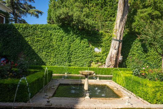 Cool Water fountain in the Alhambra in Granada, Spain, Europe on a bright sunny day