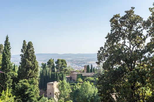 View of the bell tower of the Alhambra  from the Generalife gardens in Granada, Spain, Europe on a bright summer day