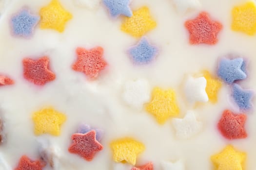 Natural homemade yogurt decorated with multicolored stars