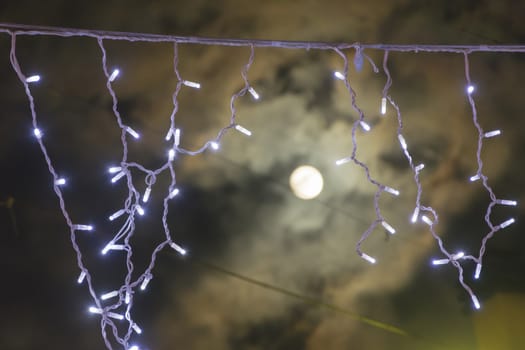 decorative led lights with a blurred moon in the clouds