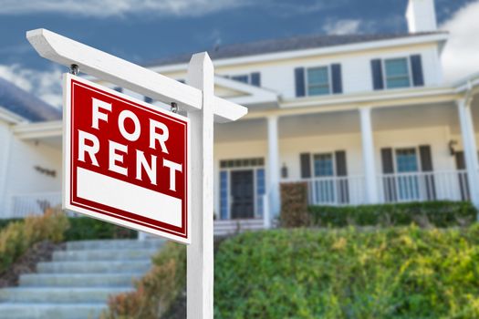 Left Facing For Rent Real Estate Sign In Front of House.