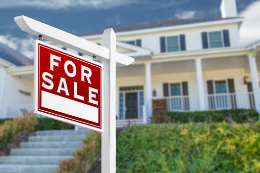 Left Facing For Sale Real Estate Sign In Front of House.