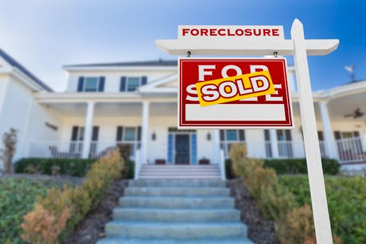 Left Facing Foreclosure Sold For Sale Real Estate Sign in Front of House.