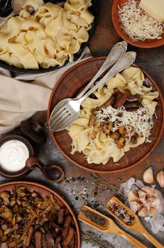 Pasta fettuccine with fried champignons, beef stroganoff, onion seasoned with cheese
