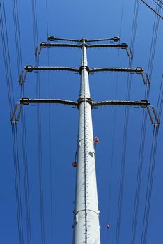Low-angle view of steel support of overhead power transmission line