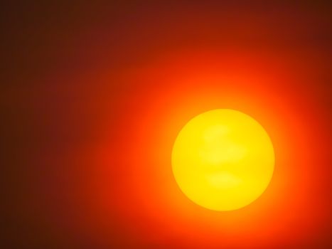 Closeup big yellow sunset on red sky background