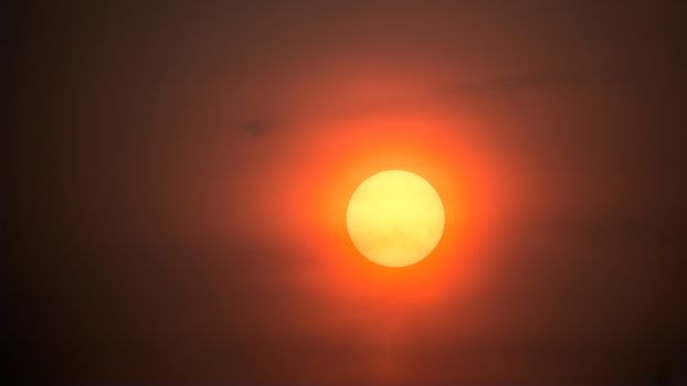 Closeup big yellow sunset on red sky background