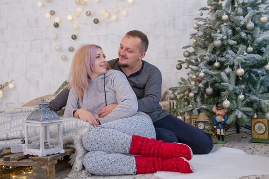 Lovely couple hugging under Christmas tree