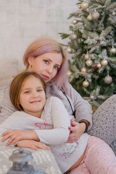 Mother and daughter hugging sweetly at Christmas