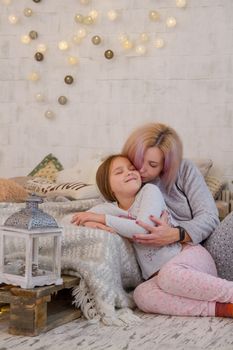 Mother and daughter hugging sweetly at Christmas