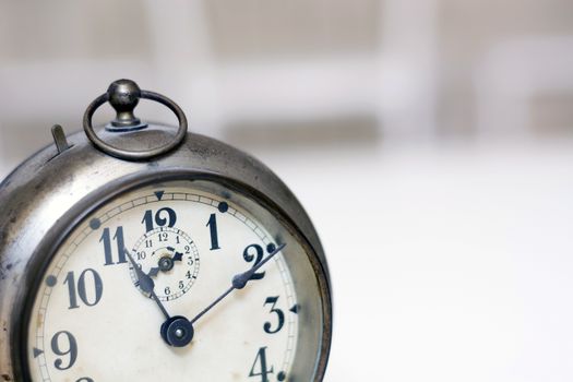 old clock on a white background. Interior shot. Nobody