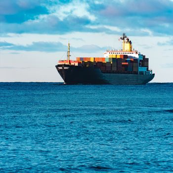 Modern black container ship moving from Baltic sea