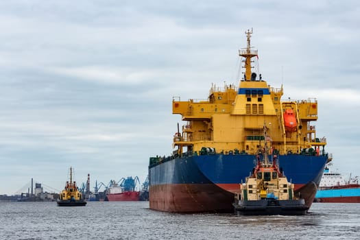 Blue cargo ship entering the port of Riga, Europe