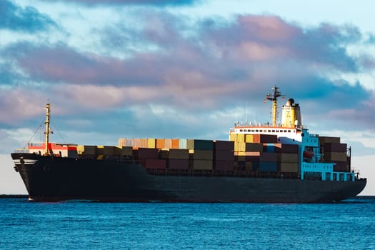 Modern black container ship moving from Baltic sea