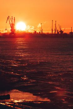 Hot winter sunrise over the cargo port in Riga